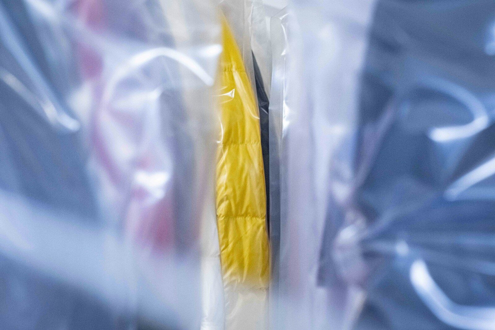 a pair of yellow and black toothbrushes wrapped in plastic